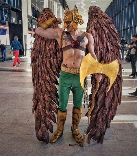 A Man Dressed Up As An Angel With Large Wings And Chains On His Chest