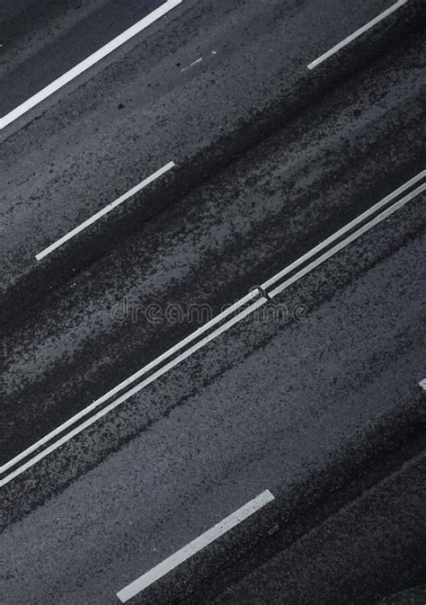 Empty Road From Above With Highway Lines And Four Lanes Wet Asphalt