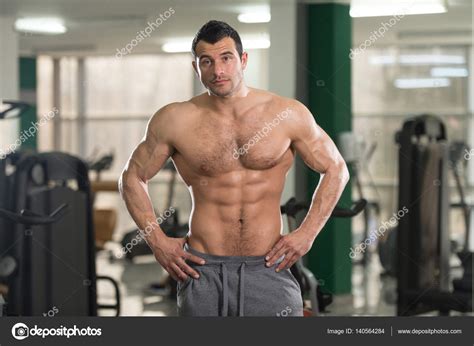Hairy Muscular Man Flexing Muscles In Gym Stock Photo By ©ibrak 140564284