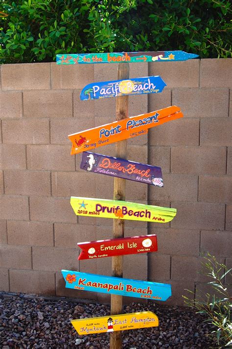A Wooden Pole With Many Different Colored Signs Attached To Its Sides