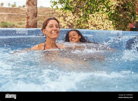 Mother And Daughter Relaxing In Private Jacuzzi People Smiling For A Summer Day Travel Summer