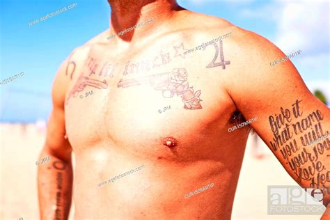 Semi Naked Man With Tattoos On Chest And Arms Stock Photo Picture And