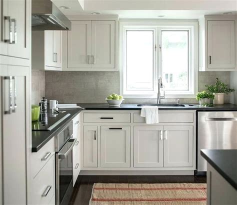 Black quartz countertops also accentuate subtle colors in painted cabinets, such as the white cabinets and crackle subway tile in this kitchen by eric aust architect. grey quartz countertops white cabinets dark gray ...