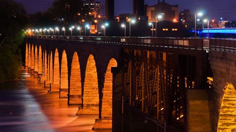 A Nighttime View Of The Stone Arch Bridge Over The Mississippi River