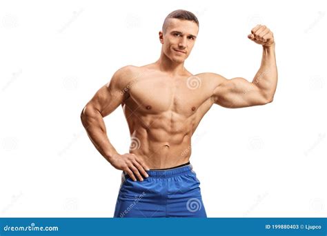 Strong Muscular Guy Flexing Bicep Muscle Topless And Looking At Camera