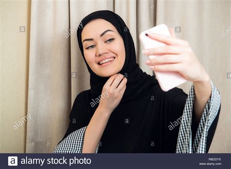 Beautiful Young Arabic Woman Taking Selfie With Her Mobile Phone Stock