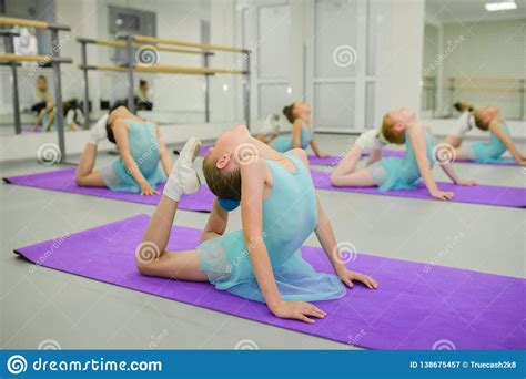 Little Ballerinas During Stretching Exercises In Ballet School Class