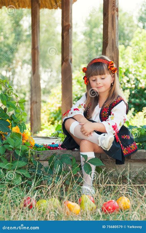Little Ukrainian Girl In National Costume Sitting On The Porch Stock