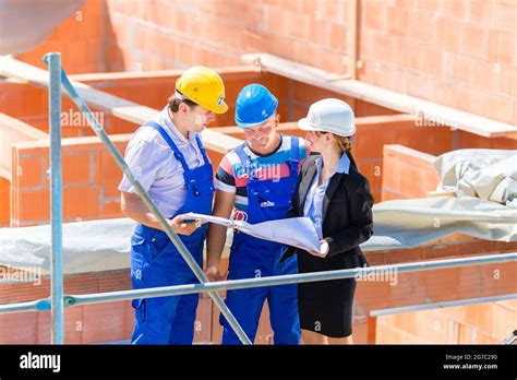 Construction Site Team Or Architect And Builder Or Worker With Helmets