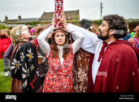 People Touch The Maypole During The Beltane Celebrations At Glastonbury