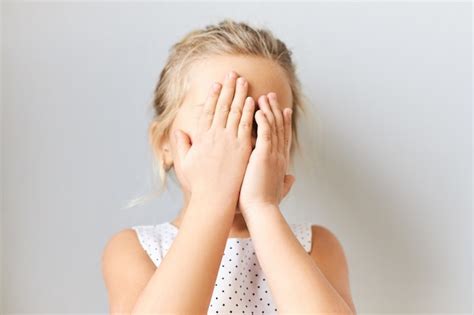 Free Photo Shy Timid Little Girl Covering Face Feeling Scared