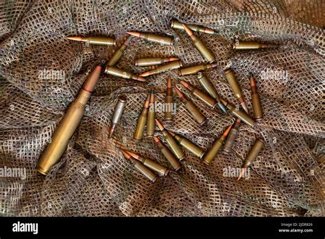 Bullets Lie On A Green Camouflage Background Military Weapons