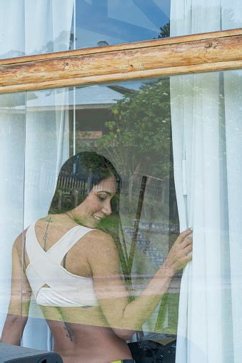 Beautiful Latin Woman Putting On Her Girdle To Take Care Of Her Body While At Home In Isolation