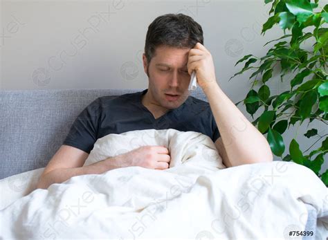 Sick Man Lying In The Bed With Fever Stock Photo Crushpixel