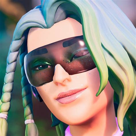 A Close Up Of A Person Wearing Sunglasses With Green Hair And Braids On