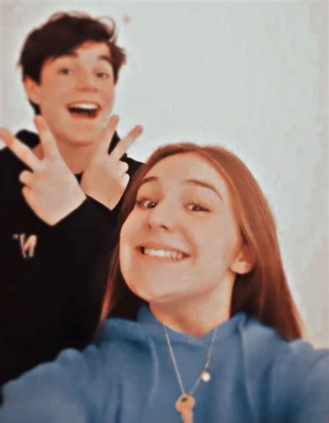 Two People Making The Peace Sign With Their Hands And One Person
