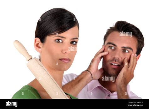 Angry Woman Threatening Man With Rolling Pin Stock Photo Alamy