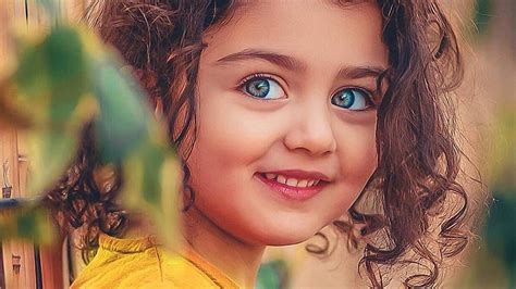 Smiley Curly Hair Blue Eyes Cute Girl In Blur Background