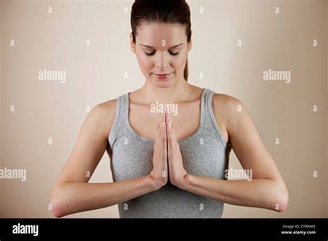 A Young Woman Meditating Hands In Prayer Position Stock Photo Alamy