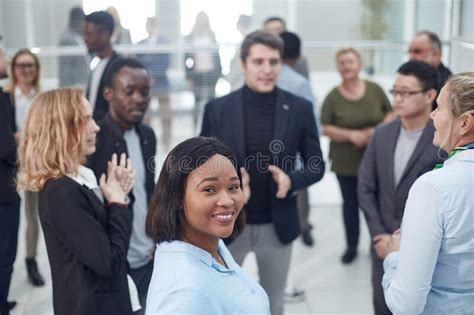 Business Colleagues Making Small Talk In Their Break Stock Photo