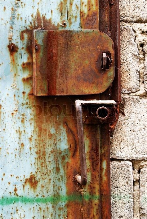 Garage doors won't open, refuse to lock or age and warp. Old rusty lock on the garage door | Stock image | Colourbox