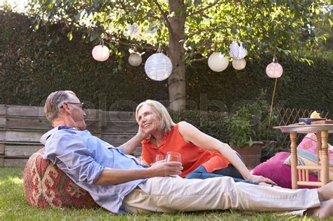 Mature Couple Enjoying Drinks In Backyard Together Stock Image Colourbox