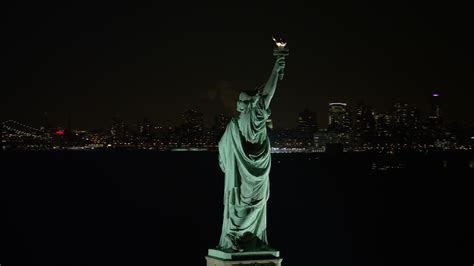 4k Aerial Video Of Orbiting The Back Of The Statue Of Liberty At Night