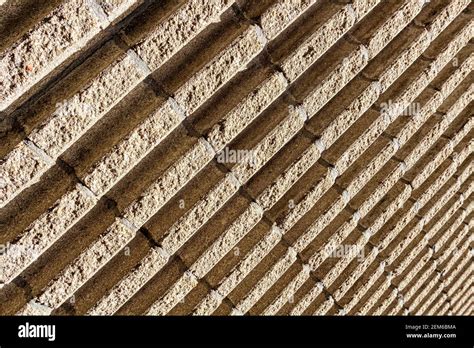 A Grooved Concrete Exterior Wall Shot At An Angle Makes Diagonal Lines