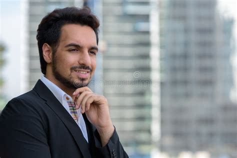 Young Happy Indian Businessman Smiling And Thinking At Rooftop I Stock
