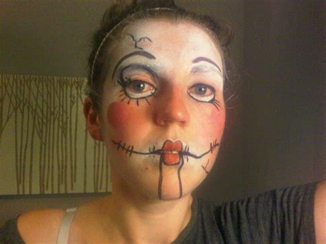 A Woman With Face Paint Painted To Look Like A Creepy Clown Is Taking A