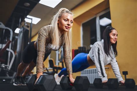 Healthy Lifestyle Portrait Of Two Young Athletic Girls Doing Plank In