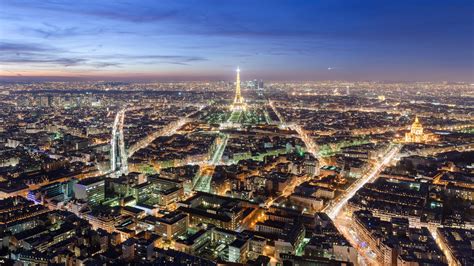 Glittering Lights Paris City And Eiffel Tower With Blue Sky Background