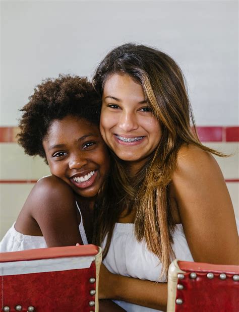 Beautiful Hispanic Girl With Braces And African American Sister By