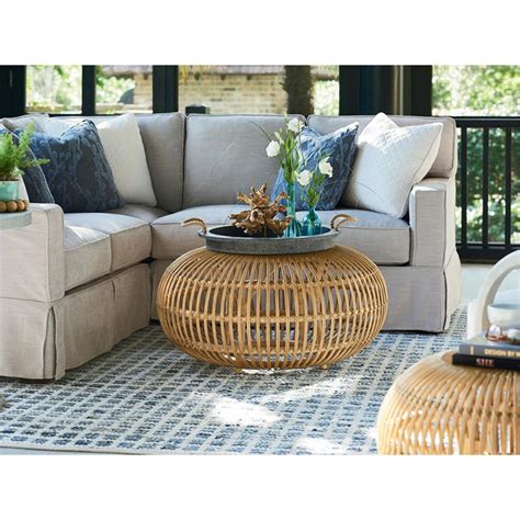 Complete with crisscrossing bar accents that connect the legs, this round coffee table is the perfect pick for serving. Nina Coastal Beach Brown Rattan Round Coffee Table - Medium