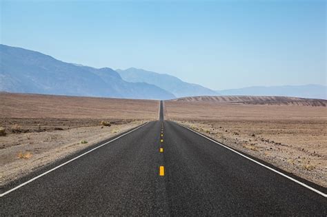 Endless And Lonely Blacktop Road Going Into Death Valley National Park