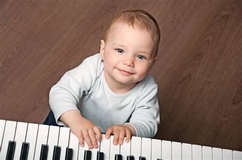Baby Play Music On Piano Keyboard Stock Photo By ©vkraskouski 28621293