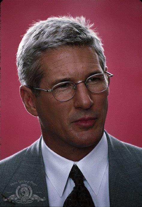 A Man Wearing Glasses And A Suit