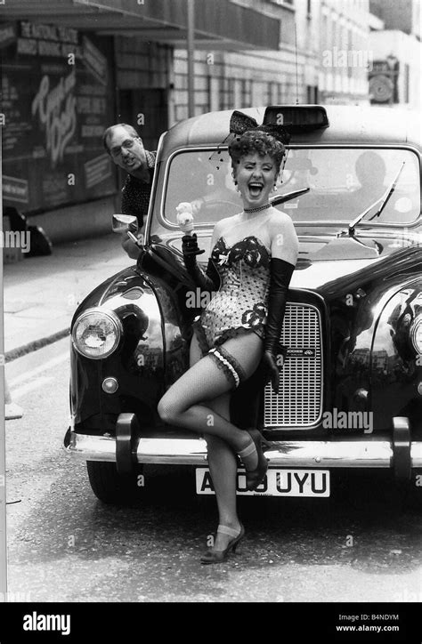 Lulu Singer Standing In Front Of A London Taxi Dressed In A Skimpy Basque And Stockings June