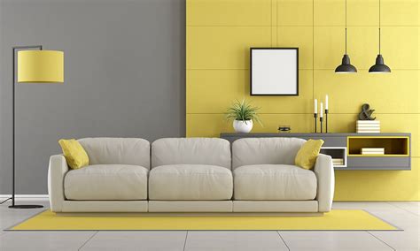 A Modern Living Room With Yellow Accents And White Furniture Including