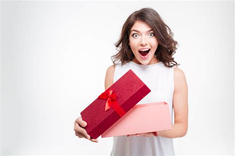 Cheerful woman opening present box | Raise the Bar