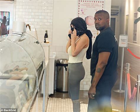Kanye West Rocks Shoulder Pads And Blue Socks While Out With Wife