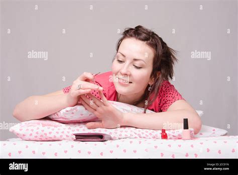 The Girl Lying In Bed And Paint On My Nails Stock Photo Alamy