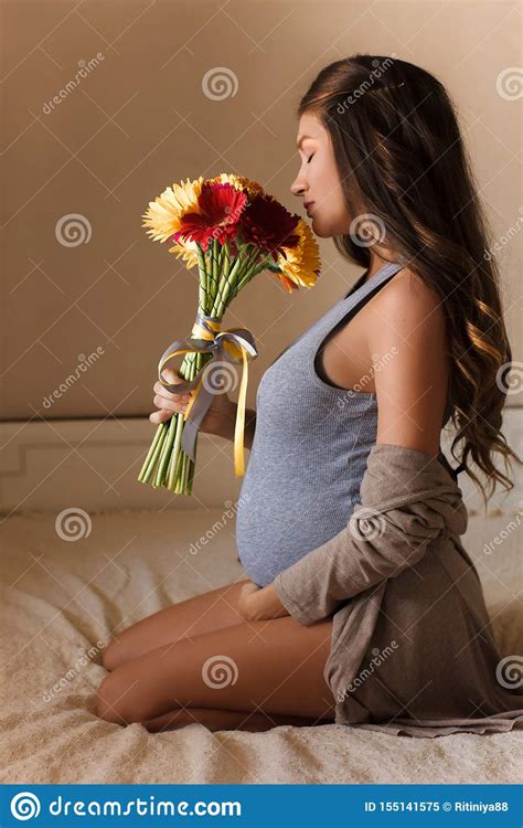 Pregnant Woman With A Bouquet Of Flowers Pregnancy Motherhood Waiting For A Miracle