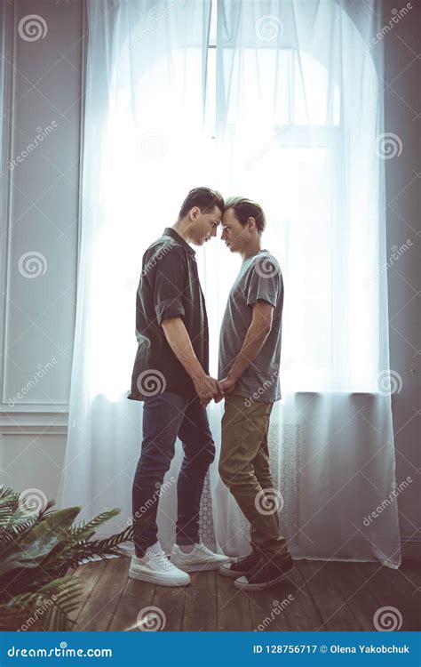 Young Gay Couple Sharing Tender Moment While Standing Near Window Stock Image Image Of Love