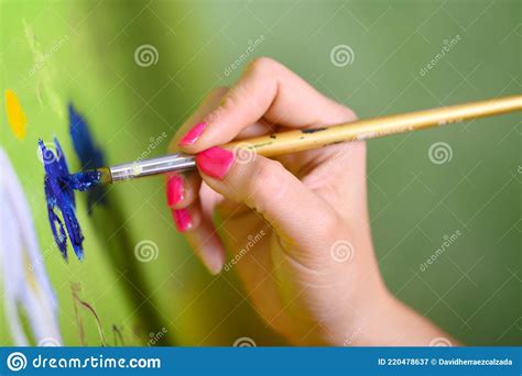 Close Up Shot Of Female Artist Hand Holding Paint Brush And Drawing