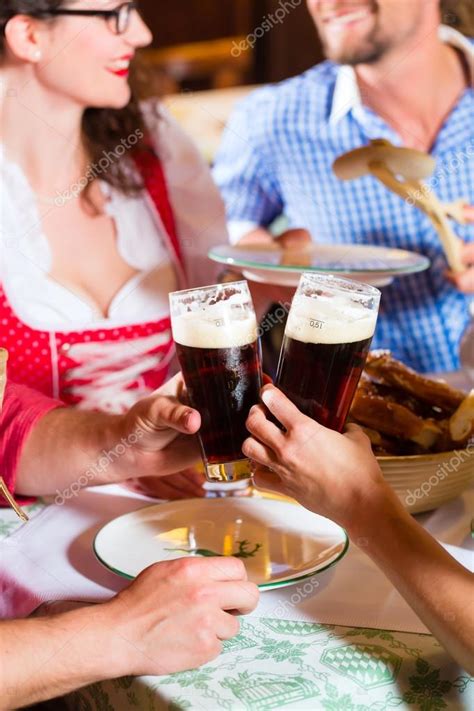 People In Bavarian Tracht Eating In Restaurant Or Pub Stock Photo By