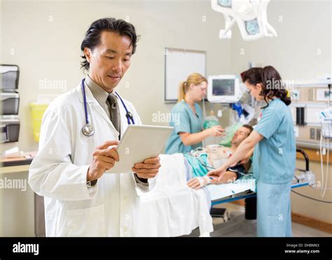 Medical Team Treating Patient In Hospital Stock Photo Alamy