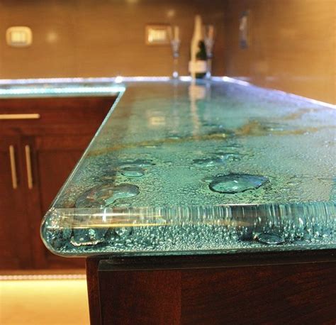 A Glass Counter Top Sitting In The Middle Of A Kitchen
