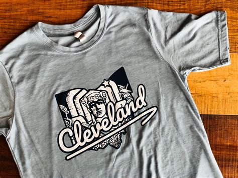 Cleveland guardians script logo and winged g baseball . Cleveland Gardian Denim T-Shirt - Market Garden Brewery Store