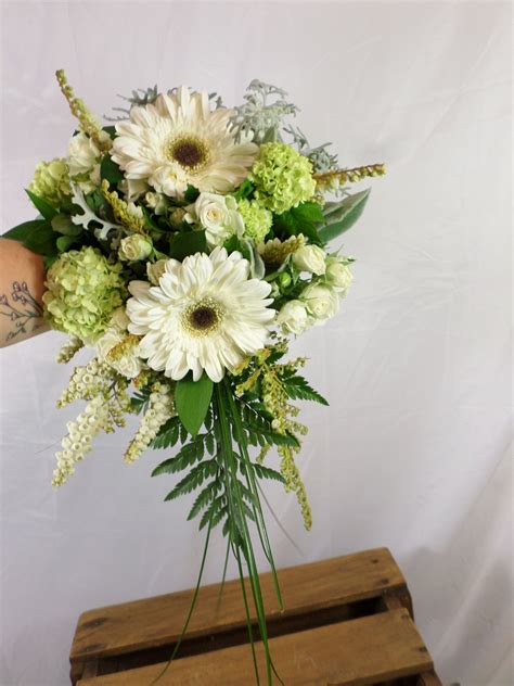 They are bright, desired, pleasantly smell. White and green small cascading wedding bouquet. Designed ...